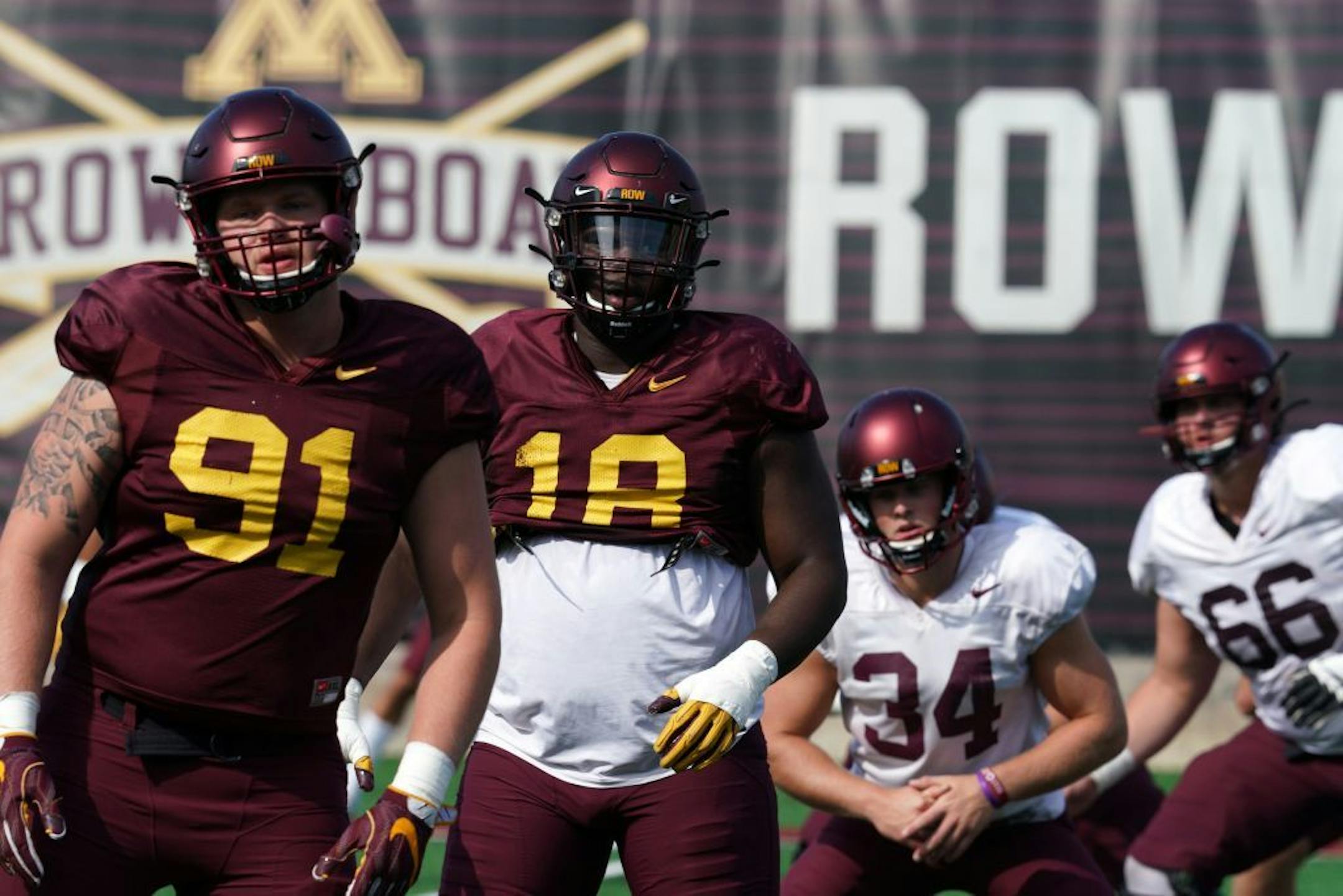 Minnesota Golden Gophers defensive tackle Micah Dew-Treadway (18) stretched with his teammates during practice Friday.