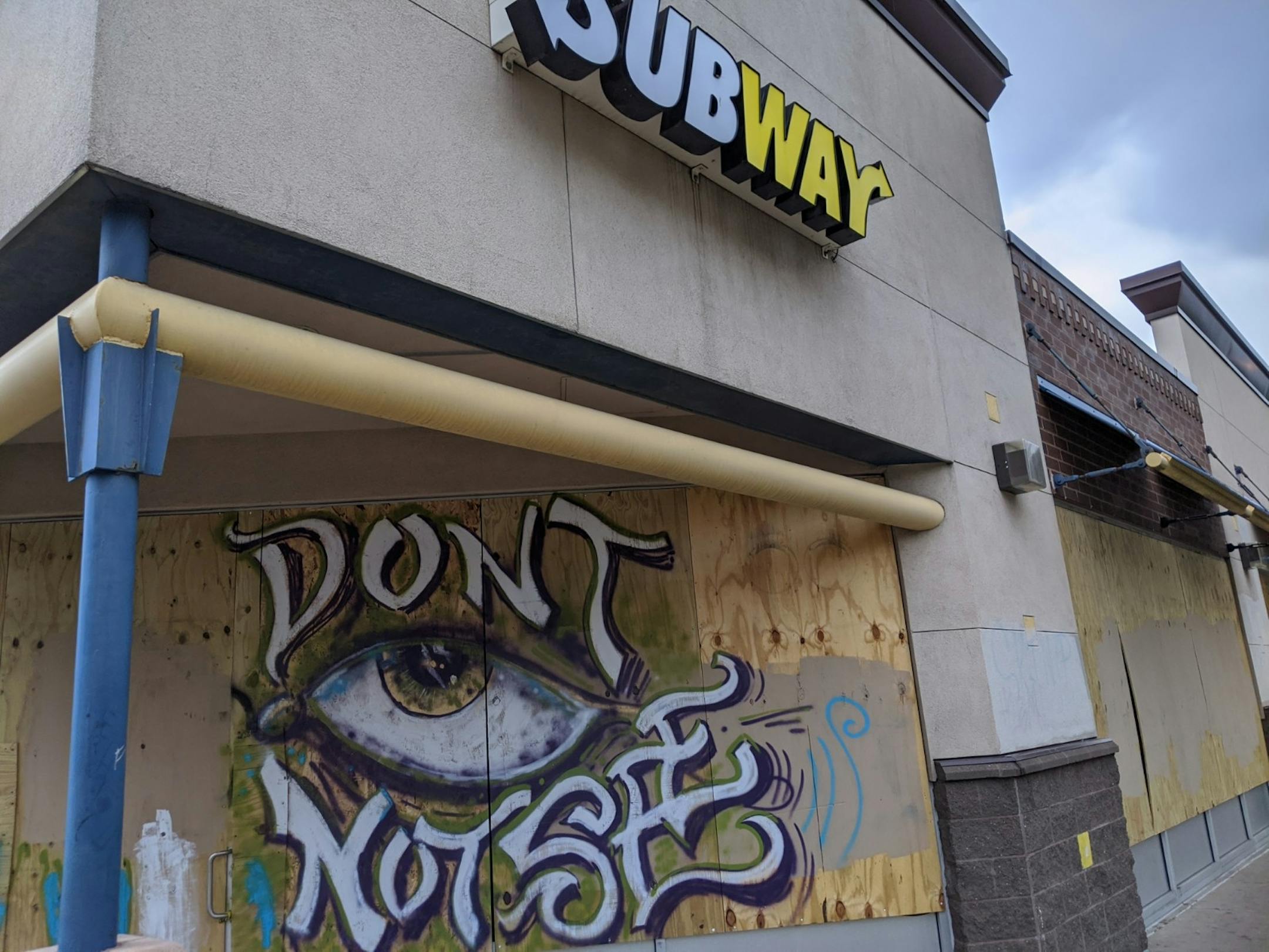A mural on Subway (2130C E. Lake St., Minneapolis) calls for viewers to wake up to what they are seeing.