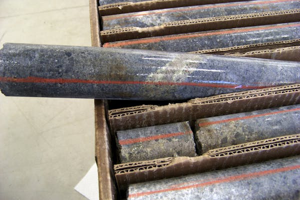 FILE - In this Oct. 4, 2011, file photo, a core sample drilled from underground rock near Ely, Minn., shows a band of shiny minerals containing copper