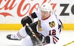 Chicago Blackhawks left wing Tomas Fleischmann (12) passed away the puck as he fell to the ice in the first period.