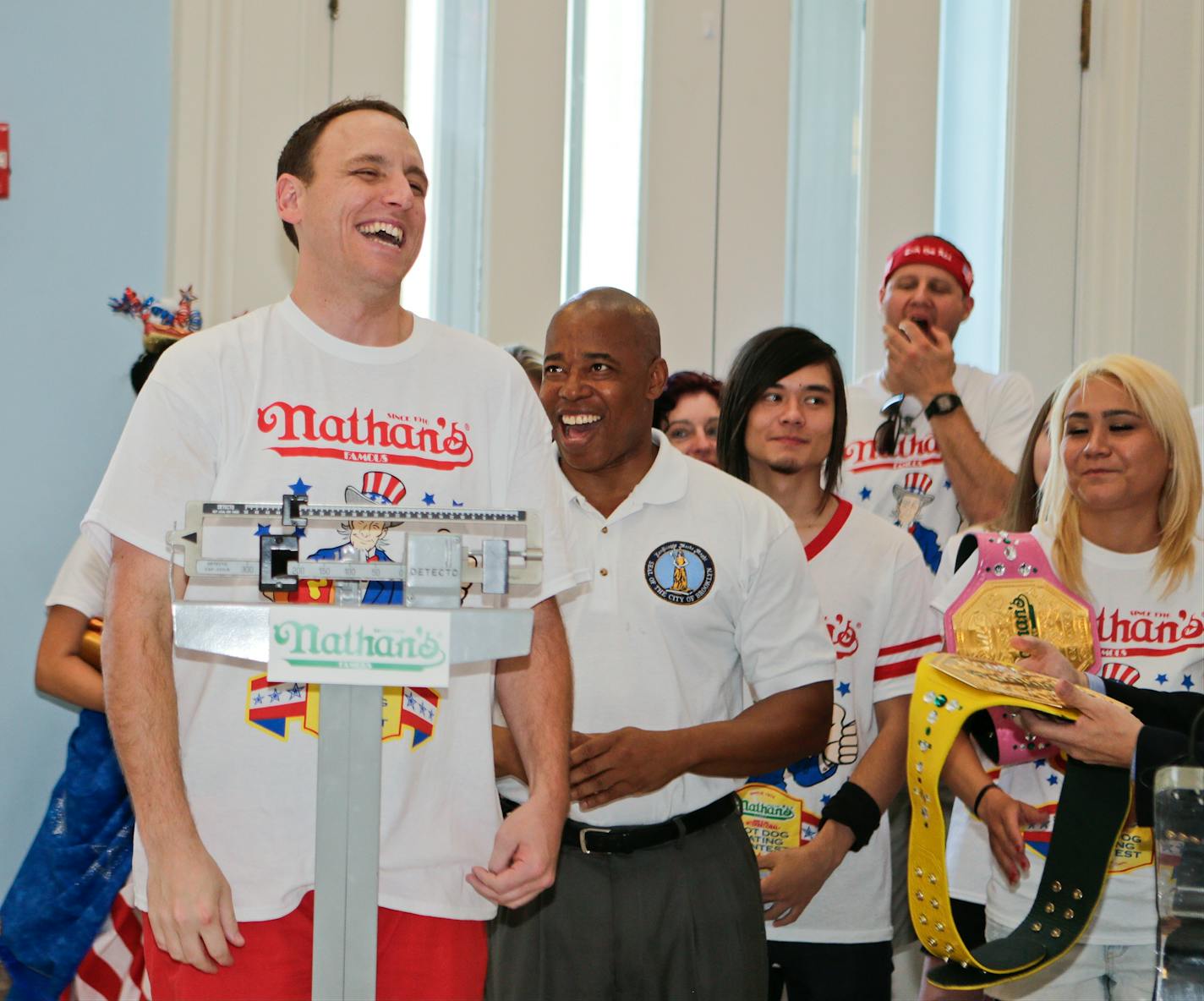 Brooklyn Borough President Eric Adams watches as Joey Chestnut, left, weighs in during a news conference to promote the upcoming Nathan's Famous Fourth of July Hot-Dog Eating Contest, Friday, July 3, 2015, at Brooklyn Borough Hall in New York.