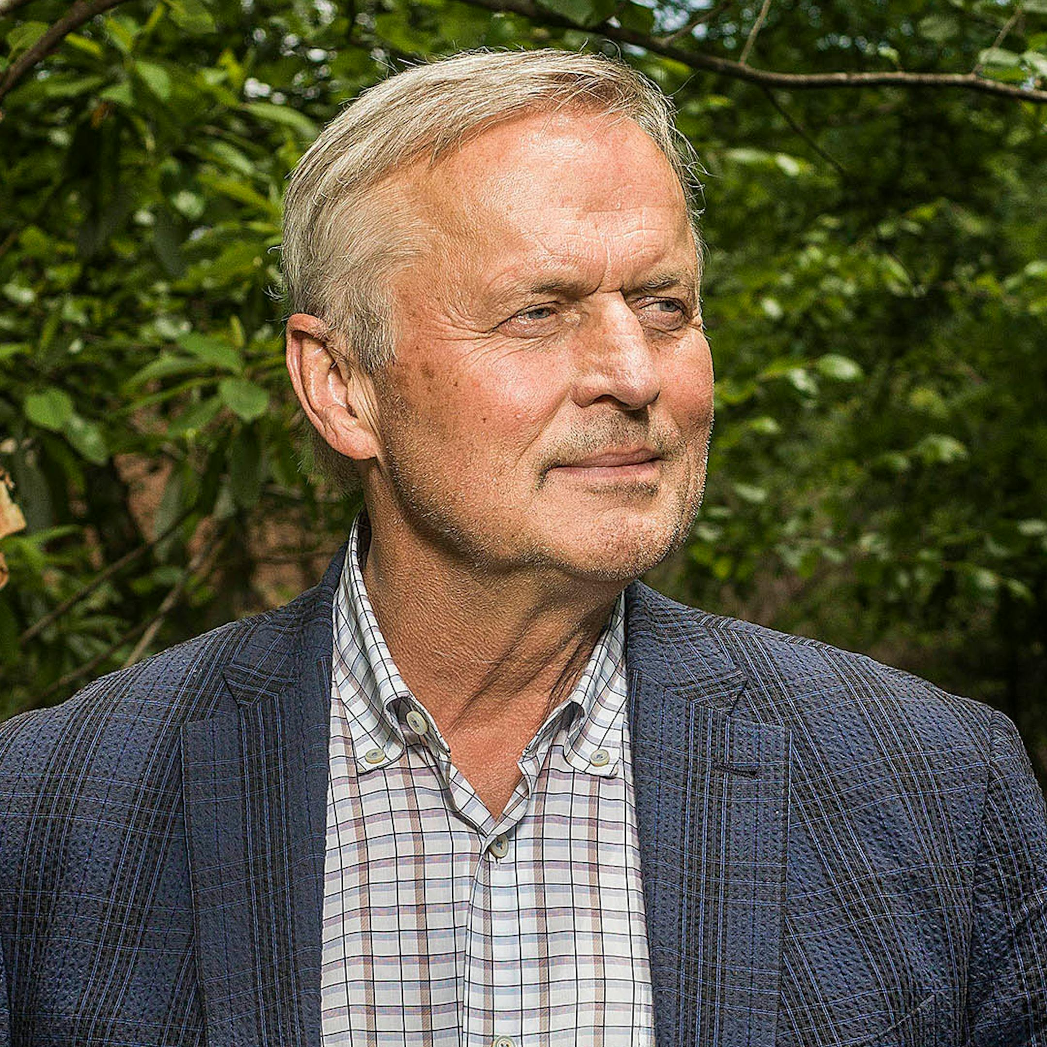 John Grisham, photographed in front of greenery