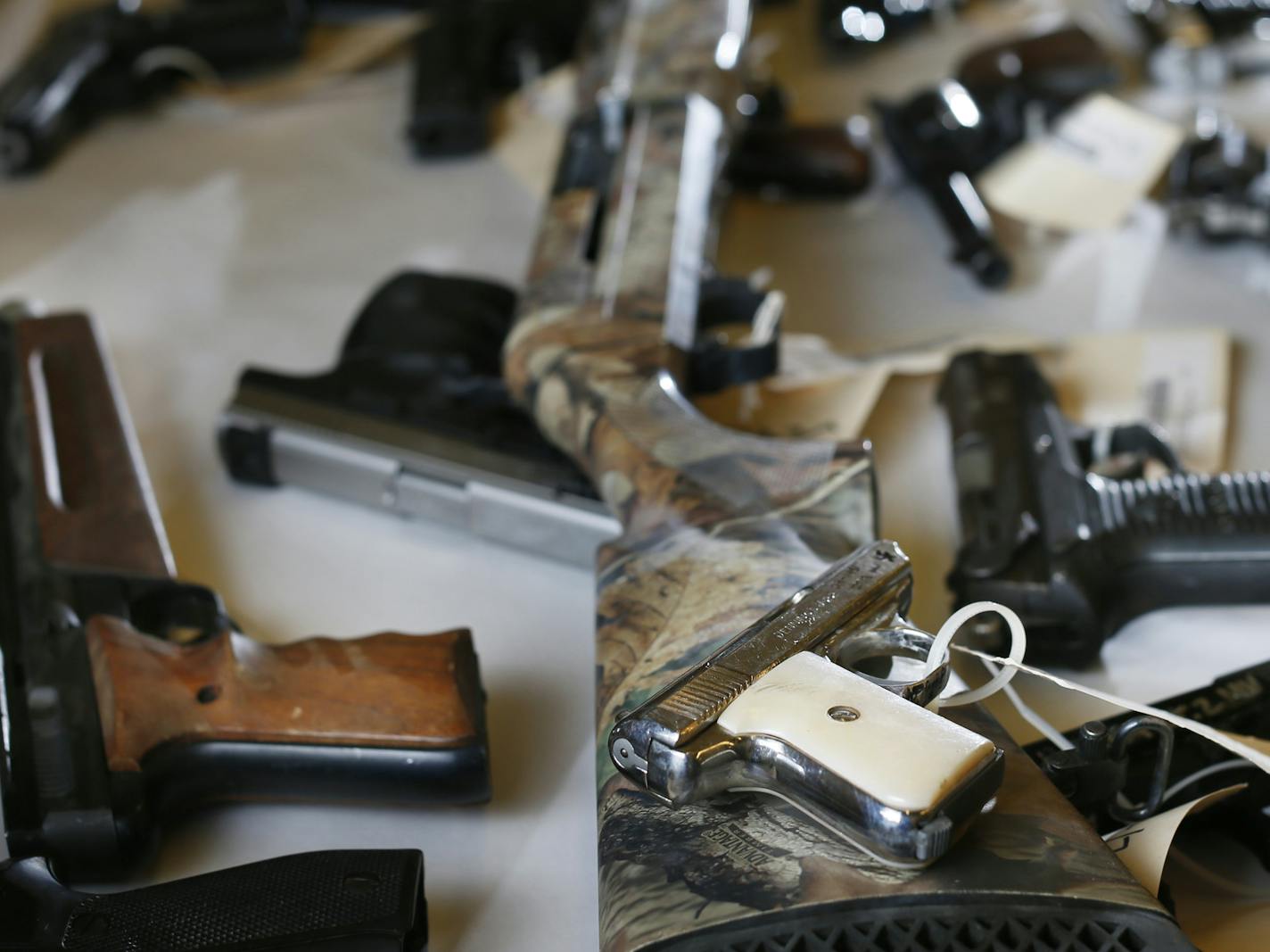 The Hennepin County Sheriff's Office keeps a collection of more than 2,000 confiscated guns that are used for training and forensics. The long shotgun in the center of the photo is similar to one used by Ray Kmetz at New Hope City Hall. Note: The exact site of this gun collection is not public, and that information is deliberately not included in this caption. Tuesday February 12, 2015 in Minneapolis, MN. ] Jerry Holt/ Jerry.Holt@Startribune.com