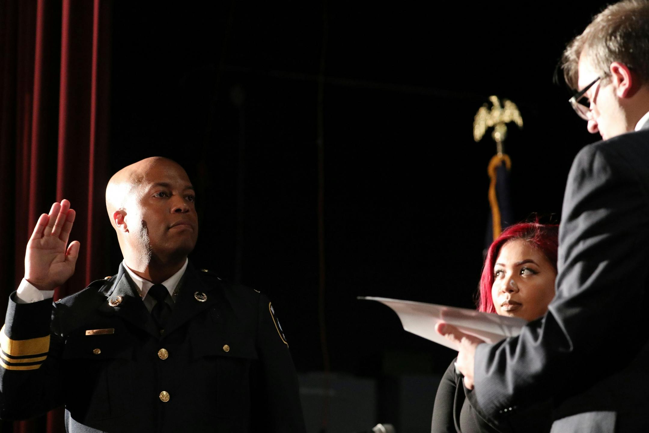 Newly appointed Minneapolis Police Chief Medaria Arradondo's took the oath of office as his daughter Nyasia looked on during a public swearing-in ceremony Friday.