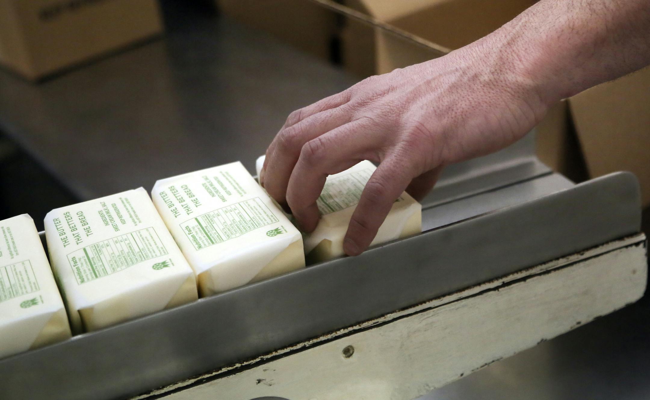Production worker Shane Malherek boxes up one-pound chunks of freshly churned butter at Hope Creamery.