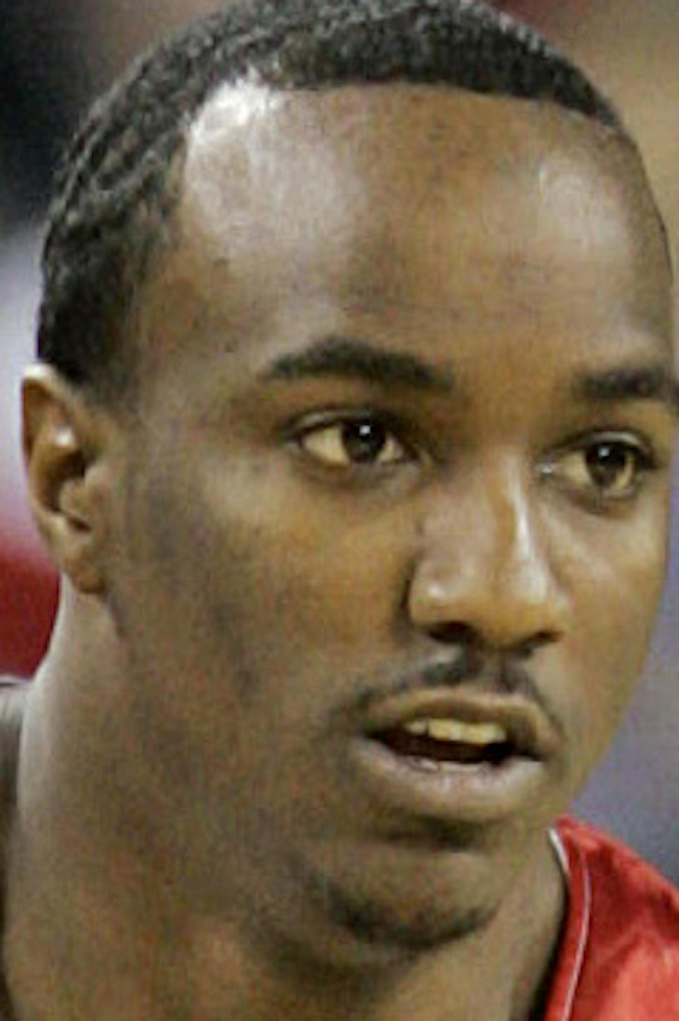 FILE - In this March 27, 2009, file photo, then-Louisville basketball player Andre McGee brings the ball up against Arizona in the first half of an NCAA Midwest regional men's college basketball tournament semifinal game in Indianapolis. An assistant University of Missouri-Kansas City basketball has resigned amid claims that he hired dancers to strip and have sex with recruits while he was a coach at Louisville. UMKC announced Andre McGee's resignation on Friday morning, Oct. 23, 2015. (AP Photo