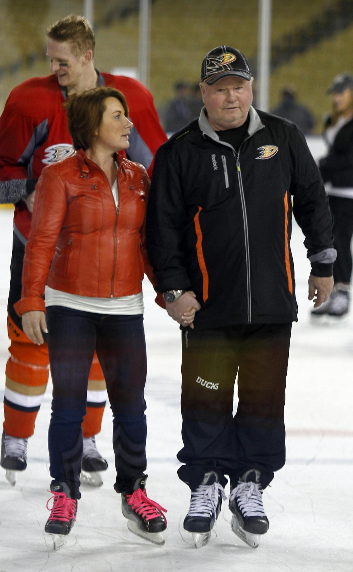 Anaheim Ducks coach Bruce Boudreau, right, skates with his wife, Crystal Boudreau, after practice for the NHL Stadium Series hockey game Friday, Jan. 24, 2014, in Los Angeles. The Los Angeles Kings and the Ducks will play outdoors at Dodger Stadium on Saturday. (AP Photo/Alex Gallardo) ORG XMIT: CAAG111