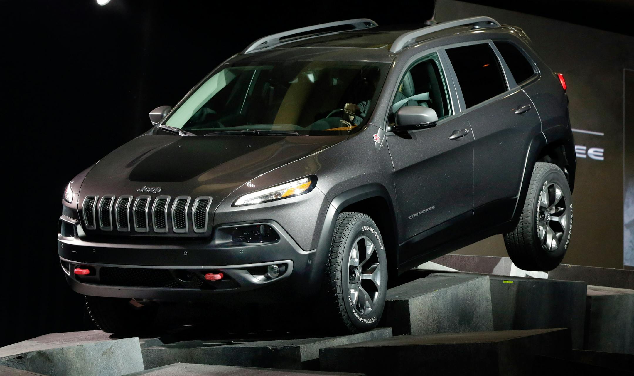 The 2014 Jeep Cherokee Trail Hawk is driven over obstacles as its presented at the New York International Auto Show, in New York's Javits Center, Wednesday, March 27, 2013. (AP Photo/Richard Drew)