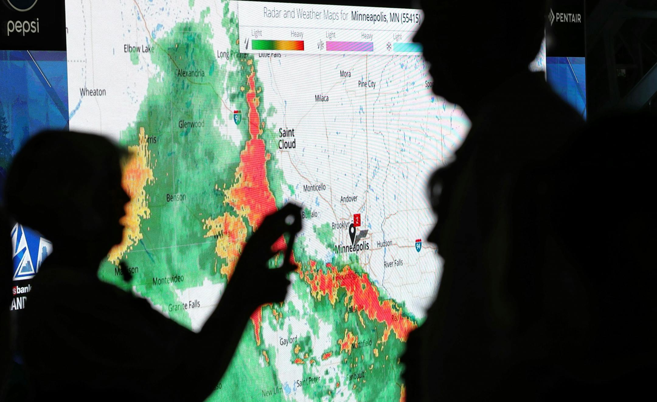 With the radar showing on the giant video board, a woman photographs a man during the public opening at the U.S. Bank Stadium Saturday, July 23, 2016, in Minneapolis, MN.