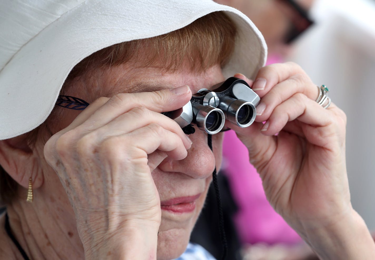 Lois Kobler of St. Paul viewed the bridge through binoculars. Boat tours are part of the MnDOT public relations campaign for the bridge.