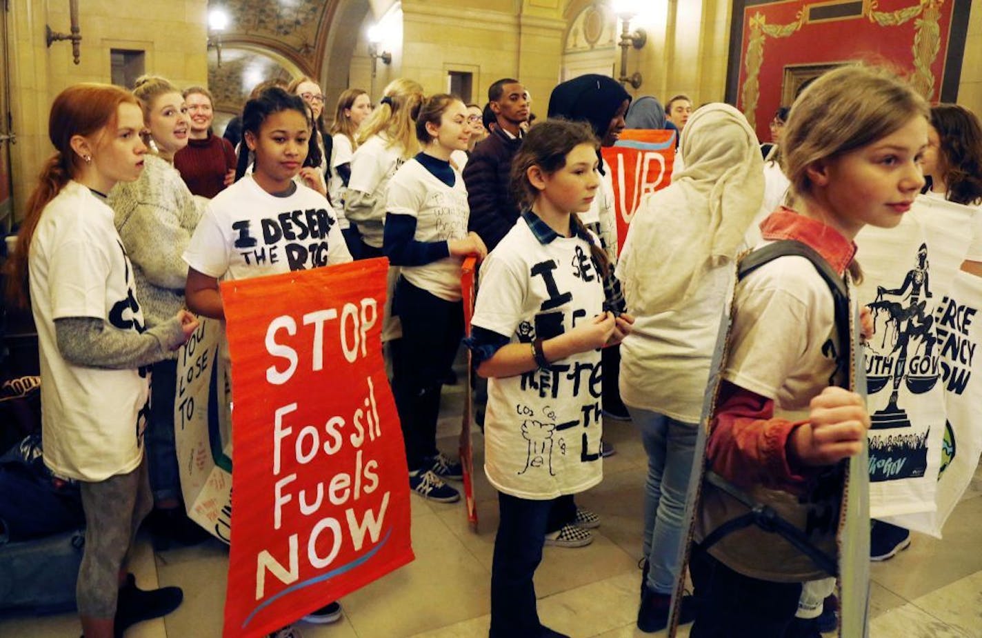 Young people from across Minnesota enter the office of Gov. Tim Walz at the state Capitol Wednesday, Jan. 9, 2019, in St. Paul, Minn. where they met him, urging him to take immediate action on climate change. The youth will launch "MN Can't Wait," a statewide campaign led by middle school and high school students with support from environmental organizations.