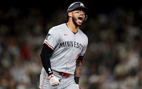The Twins' Carlos Correa celebrates after hitting a go-ahead two-run home run in the 10th inning Friday at Seattle.