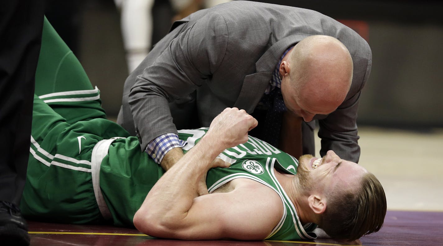 Boston Celtics' Gordon Hayward grimaces in pain in the first half of an NBA basketball game against the Cleveland Cavaliers, Tuesday, Oct. 17, 2017, in Cleveland. Just five minutes into his Boston career, new Celtics star forward Gordon Hayward gruesomely broke his left ankle, an injury that may end his season. (AP Photo/Tony Dejak)