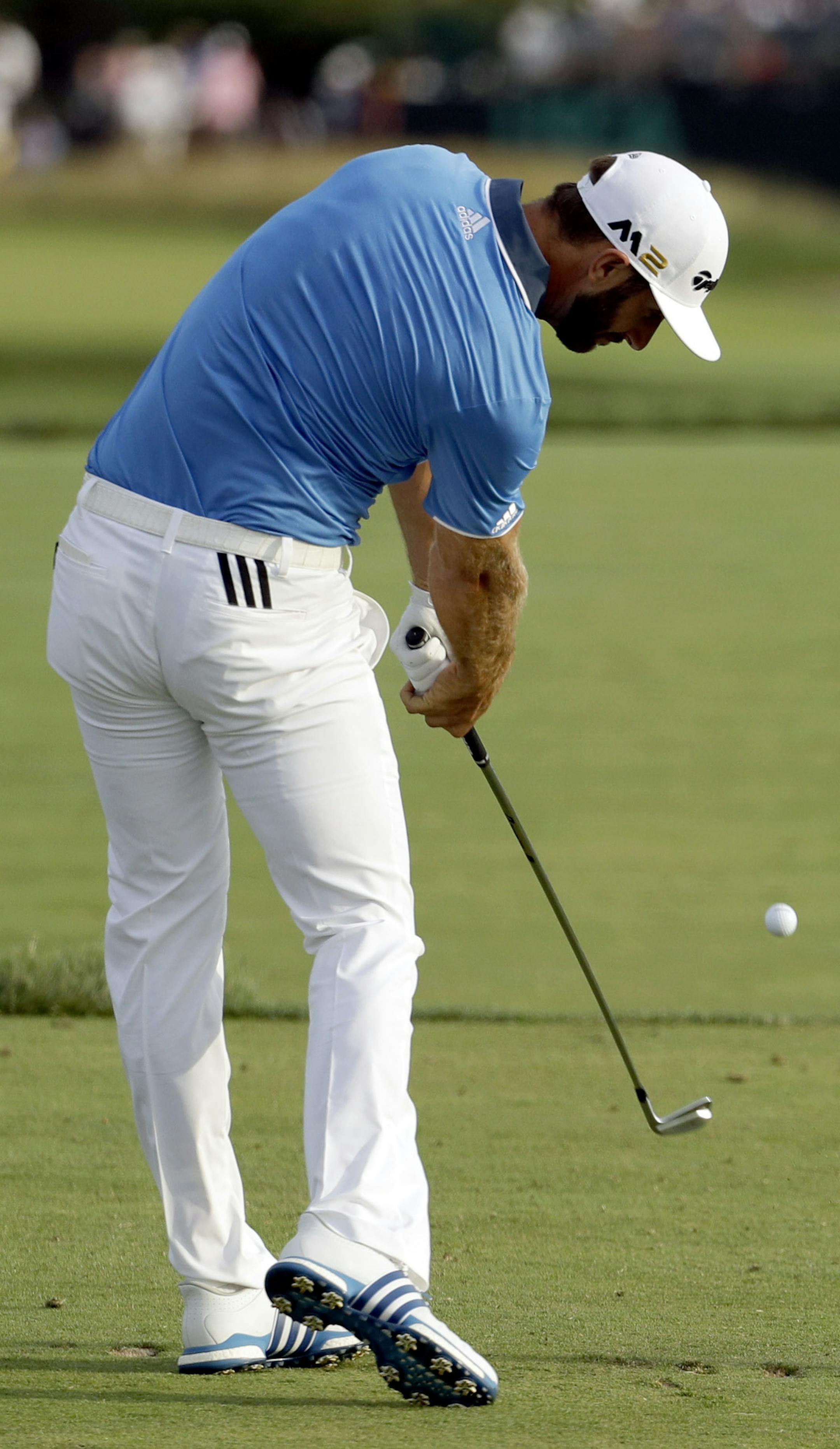 Dustin Johnson watches his tee shot on the eighth hole during third round of the U.S. Open golf championship at Oakmont Country Club on Saturday, June 18, 2016, in Oakmont, Pa. (AP Photo/Charlie Riedel)