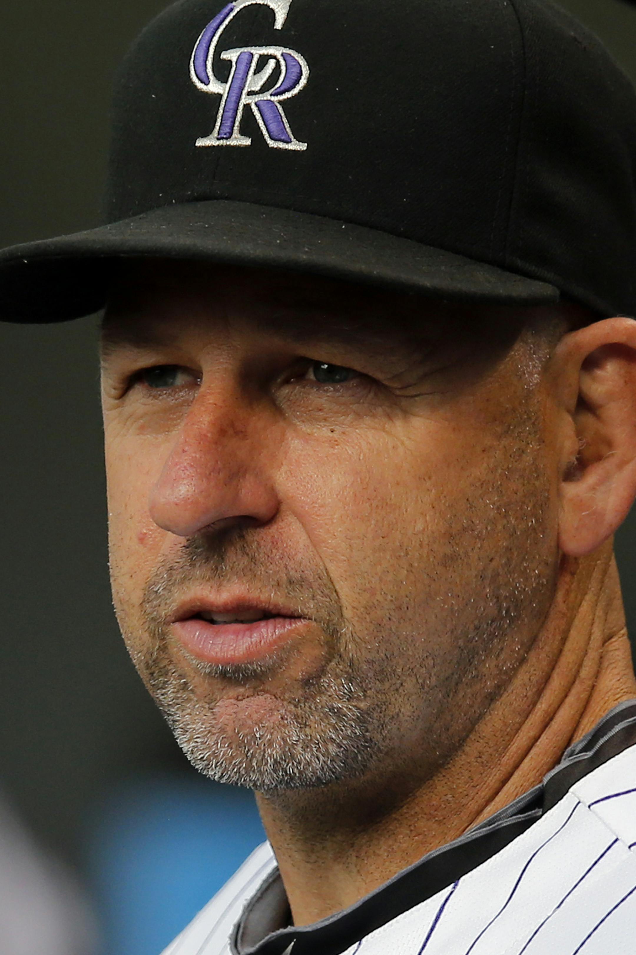 Colorado Rockies manager Walt Weiss look to the field during the first inning of a baseball game against the Cincinnati Reds on Friday, Aug. 15, 2014, in Denver. (AP Photo/Jack Dempsey) ORG XMIT: COJD120