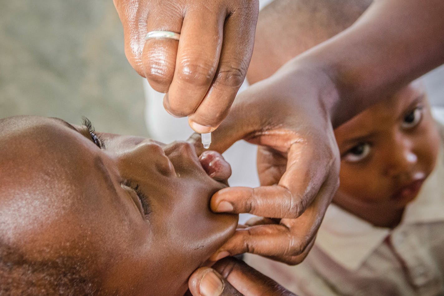 A child receives a polio vaccination drop during the nationwide vaccination campaign against measles, rubella and polio targeting all children under 15 years old in Nkozi town, about 84 km from the capital Kampala, on October 19, 2019. (Badru Katumba/AFP/Getty Images/TNS)