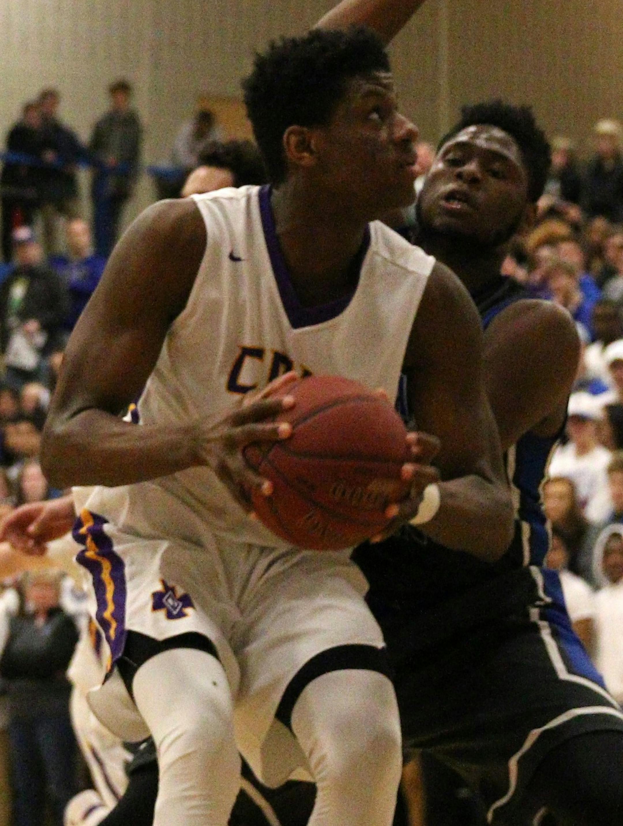 Daniel Oturu (with ball), Cretin-Derham Hall boys' basketball. Class 4A, Section 4 championship Cretin-Derham Hall vs Tartan 3/16/2017 Photos by Cheryl Myers