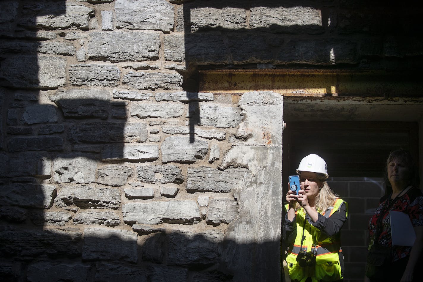 Nikki Rugh of H+U Construction took photos of the mill ruins they've unearthed during a tour, Wednesday, August 28, 2019 in Minneapolis, MN. Water Works is a multimillion dollar project that will radically change the look of the riverfront. What's interesting is that they've unearthed historic mill remnants that will be a main feature of the project. ] ELIZABETH FLORES &#x2022; liz.flores@startribune.com