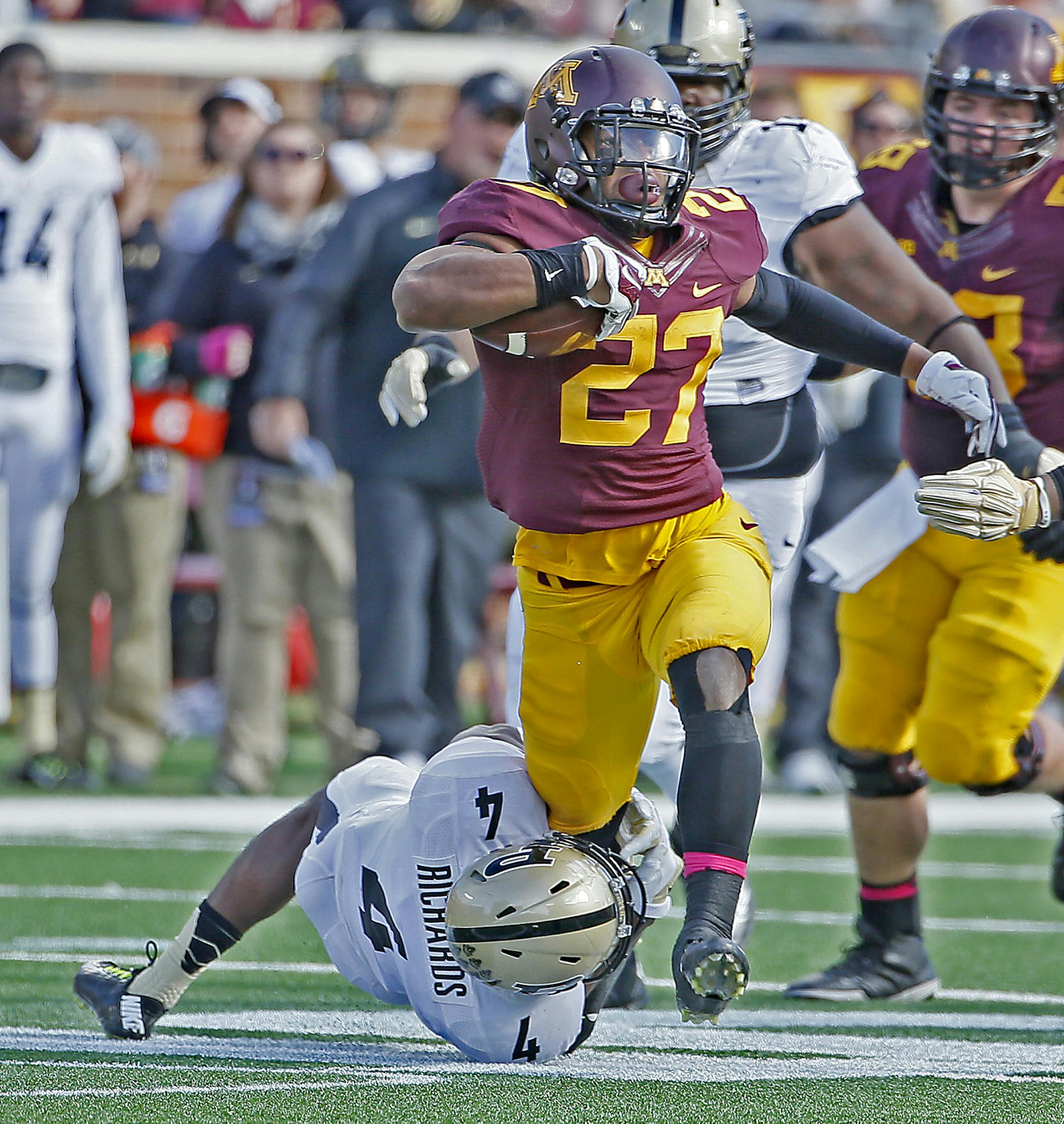 Gophers' running back David Cobb (27) can't be stopped by Purdue's safety Taylor Richards (4) in the first quarter as the Minnesota Gophers took on the Purdue Boilermakers, Saturday, Oct. 18, 2014 at TCF Bank Stadium in Minneapolis. Minnesota came out on top, 39-38. (Elizabeth Flores/Minneapolis Star Tribune/MCT) ORG XMIT: 1158853