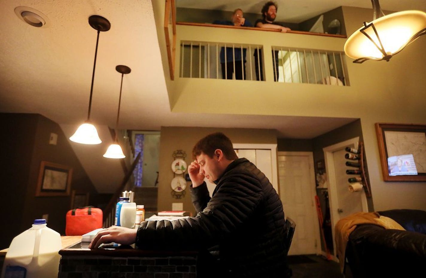 Thomas Hodgson, 26, is on the autism spectrum and has a mild intellectual disability. Here, Hodgson, who lives with his parents, has breakfast as his mom Louise, top left, and brother Brien, top right, look on from above Wednesday, March 13, 2019, in Eagan, MN.