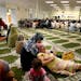 Women sat and some children read books on the floor as Imam Ezzeddeen Taha spoke during a prayer service at the new Islamic Institute of Minnesota Mos
