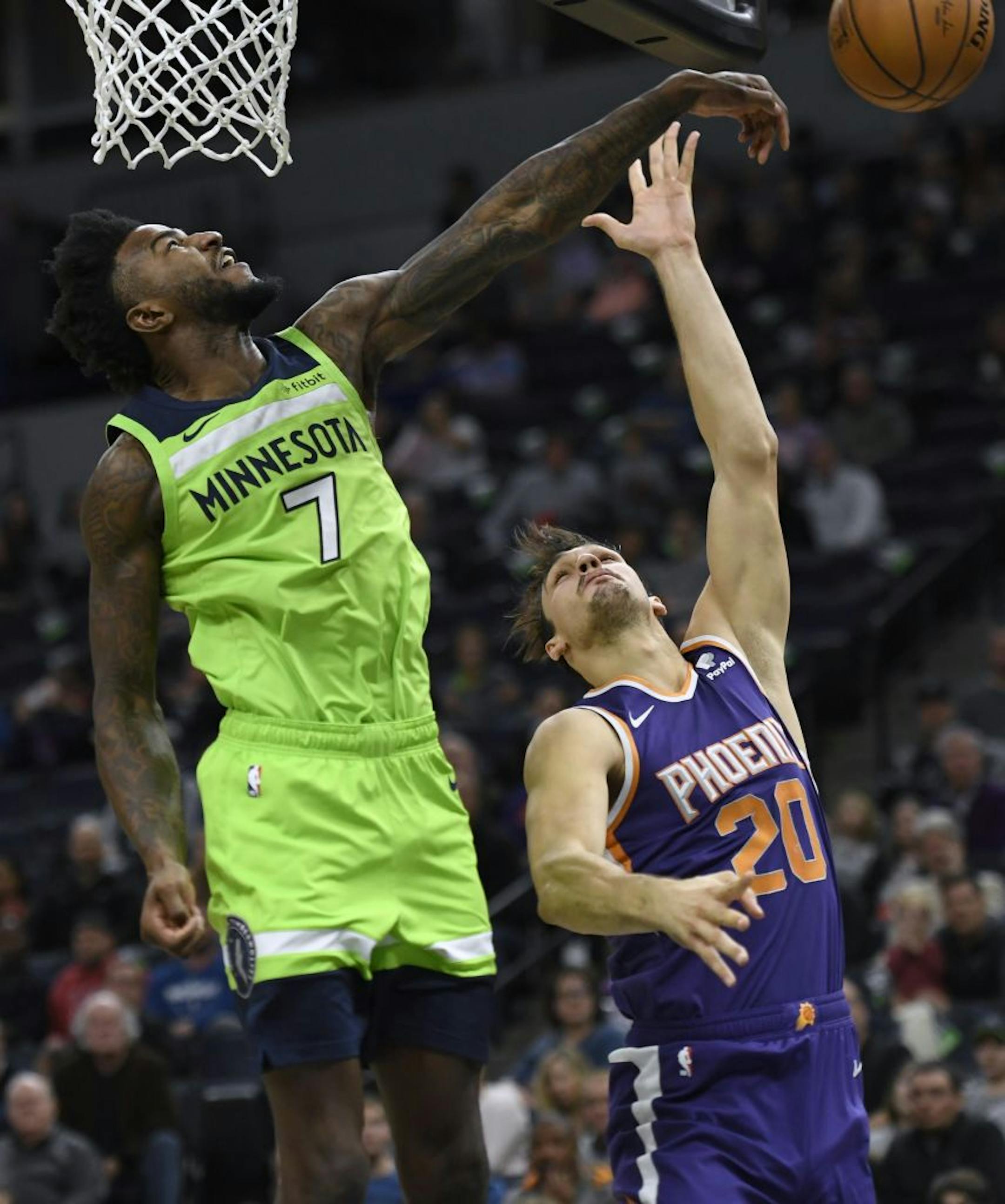 Minnesota Timberwolves forward Jordan Bell (7) blocks a shot by Phoenix Suns forward Dario Saric (20) during the second quarter of an NBA basketball game Saturday, Nov. 23, 2019, in Minneapolis.