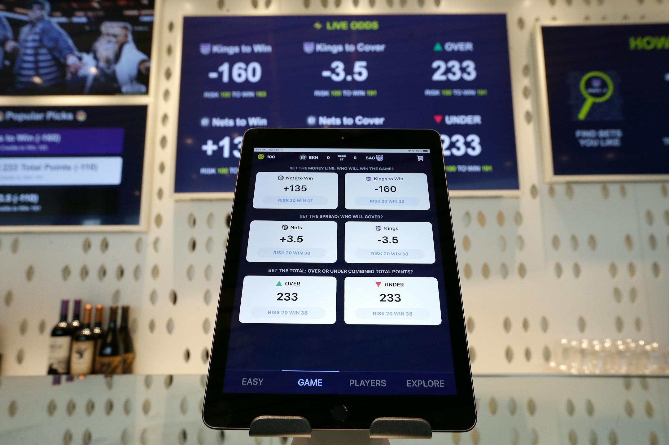 FILE - In this March 19, 2019, file photo, an iPad displays the types of free bets that could be placed at the Golden 1 Center's Skyloft Predictive Gaming Lounge in Sacramento, Calif. The campaign that could bring legalized sports betting to California has become the most expensive ballot-initiative fight in state history. Two rival proposals on the November ballot are pitting wealthy Indian tribes against FanDuel, DraftKings and other online gambling companies, in a contest over what could become the nation's most lucrative marketplace. (AP Photo/Rich Pedroncelli, File)