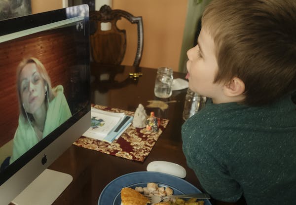 Sylwia Pawlak-Reynolds, in Poland, speaks with her son William, 7, of south Minneapolis, via Skype.