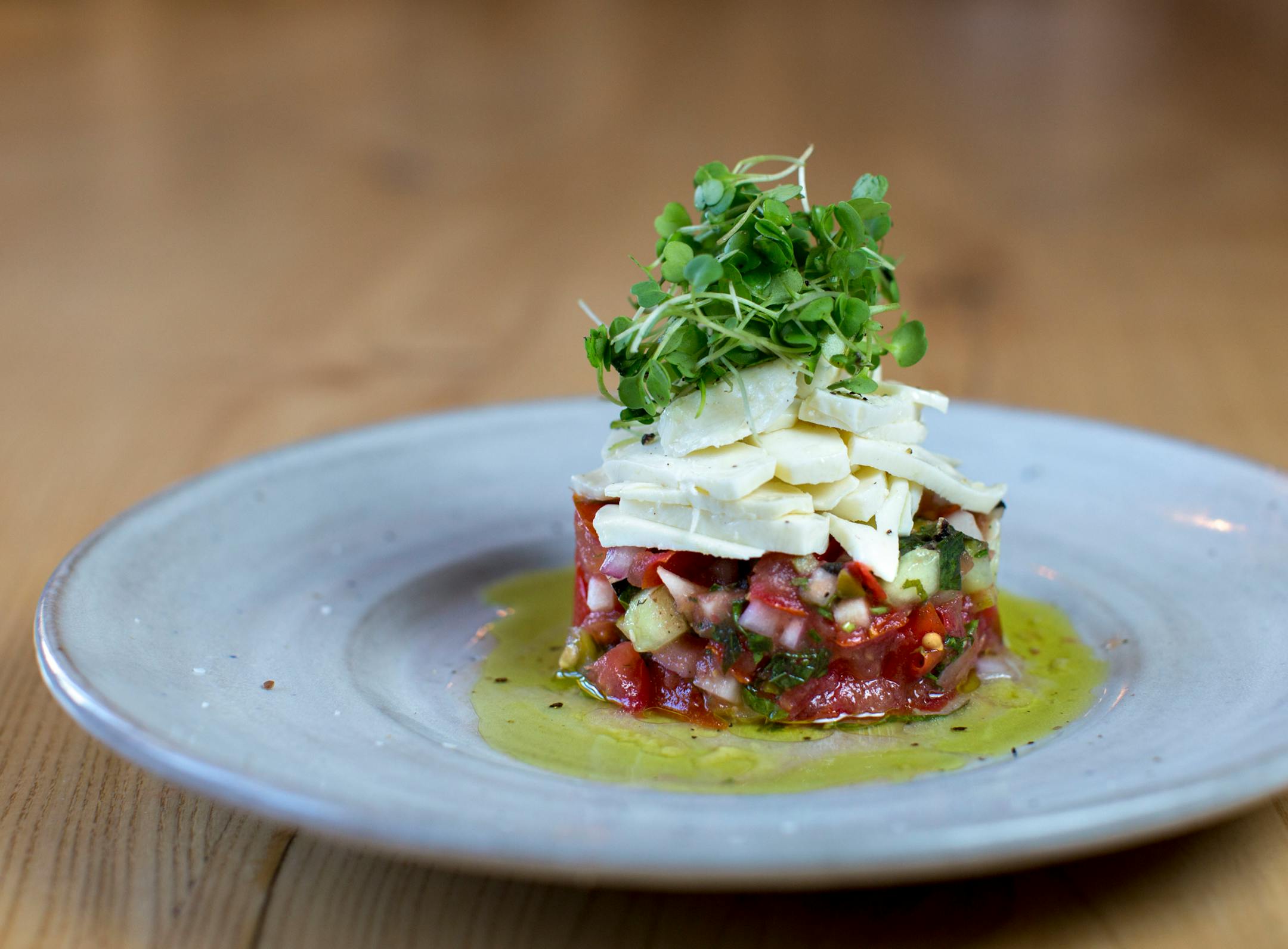 Driftless Cafe serves housemade mozzarella with gazpacho. 85% of the food budget is spent on farms within a 30 mile radius, according to Luke Zahm. ] COURTNEY PEDROZA • courtney.pedroza@startribune.com June 22-24, 2017; Wisconsin restaurants, cafes, bars, bakeries and breweries; Dining along the Mississippi River.