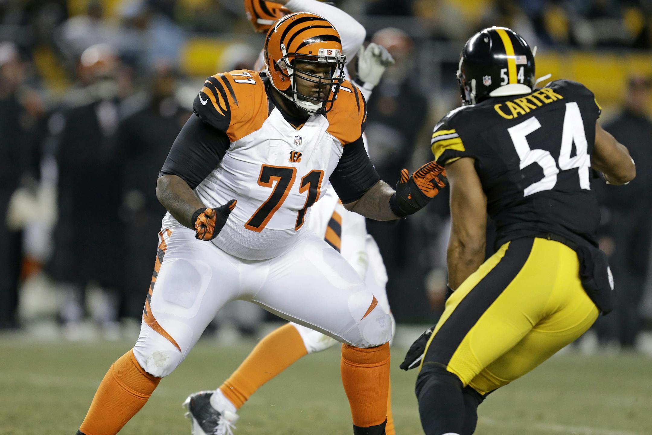 Cincinnati Bengals tackle Andre Smith (71) blocks Pittsburgh Steelers outside linebacker Chris Carter (54) during the fourth quarter of an NFL football game in Pittsburgh, Sunday, Dec. 15, 2013. The Steelers won 30-20. (AP Photo/Gene J. Puskar) ORG XMIT: PAKS