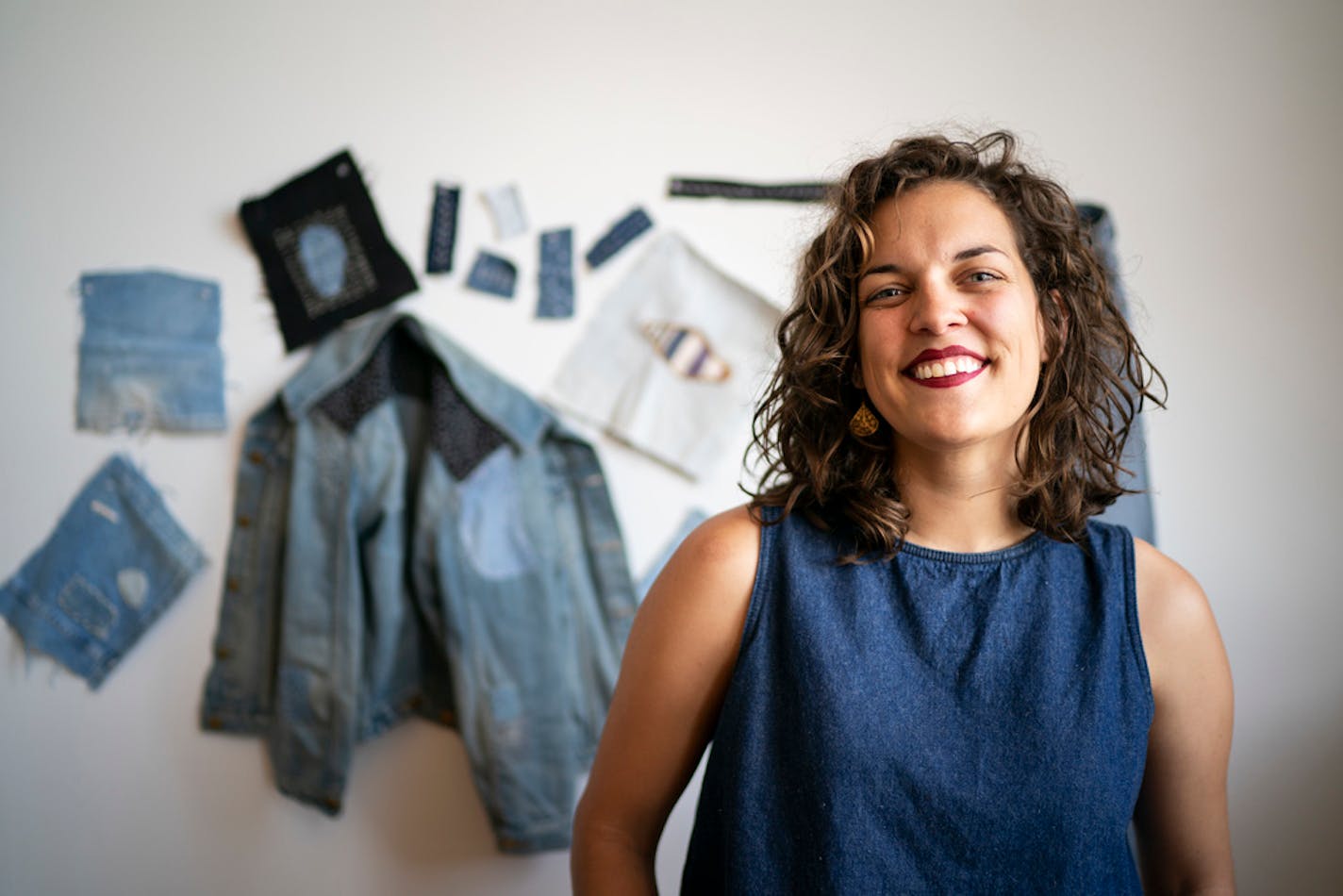 Minneapolis art therapist and vintage seller Lauren Callis Erickson with several examples of her "visible mending" handiwork.