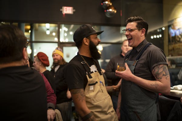 Justin Sutherland laughed with fellow Top Chef contestant Brian Young who can to St. Paul to help Sutherland host a six course meal at the Handsome Ho