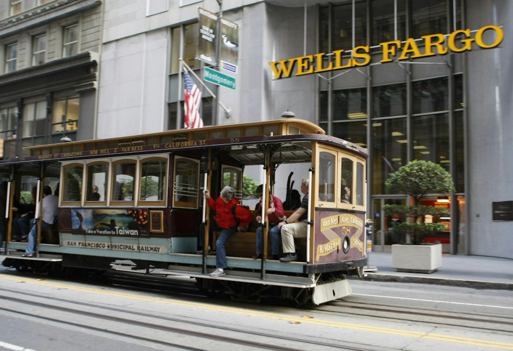 In this Oct. 7, 2010 photo, the trolley passes a Wells Fargo Bank in downtown San Francisco. Wells Fargo & Co. said Wednesday, Oct. 20, its third-quarter profit rose 19 percent and beat forecast as losses from failed loans fell for the third straight quarter. (AP Photo/Paul Sakuma)