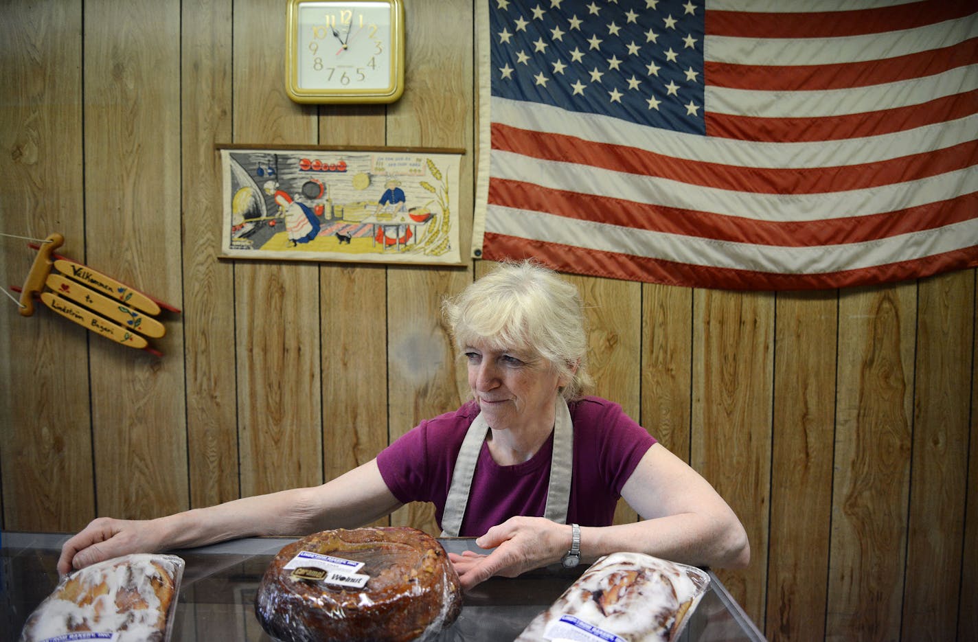 Bernie Coulombe, the owner of Lindstrom Bakery, stood with her baked goods in Lindstrom Bakery in the Chisago Lakes Area, Minn., on Friday June 19, 2015. Coulombe has owned the bakery for 42 years and continues to work a 1 AM - 6 PM shift six days per week. The Chisago Lakes Area is made up of Chisago City, Lindstrom, Scandia, Center City, Shafer, Taylors Falls and Almelund. ] RACHEL WOOLF &#x2022; rachel.woolf@startribune.com