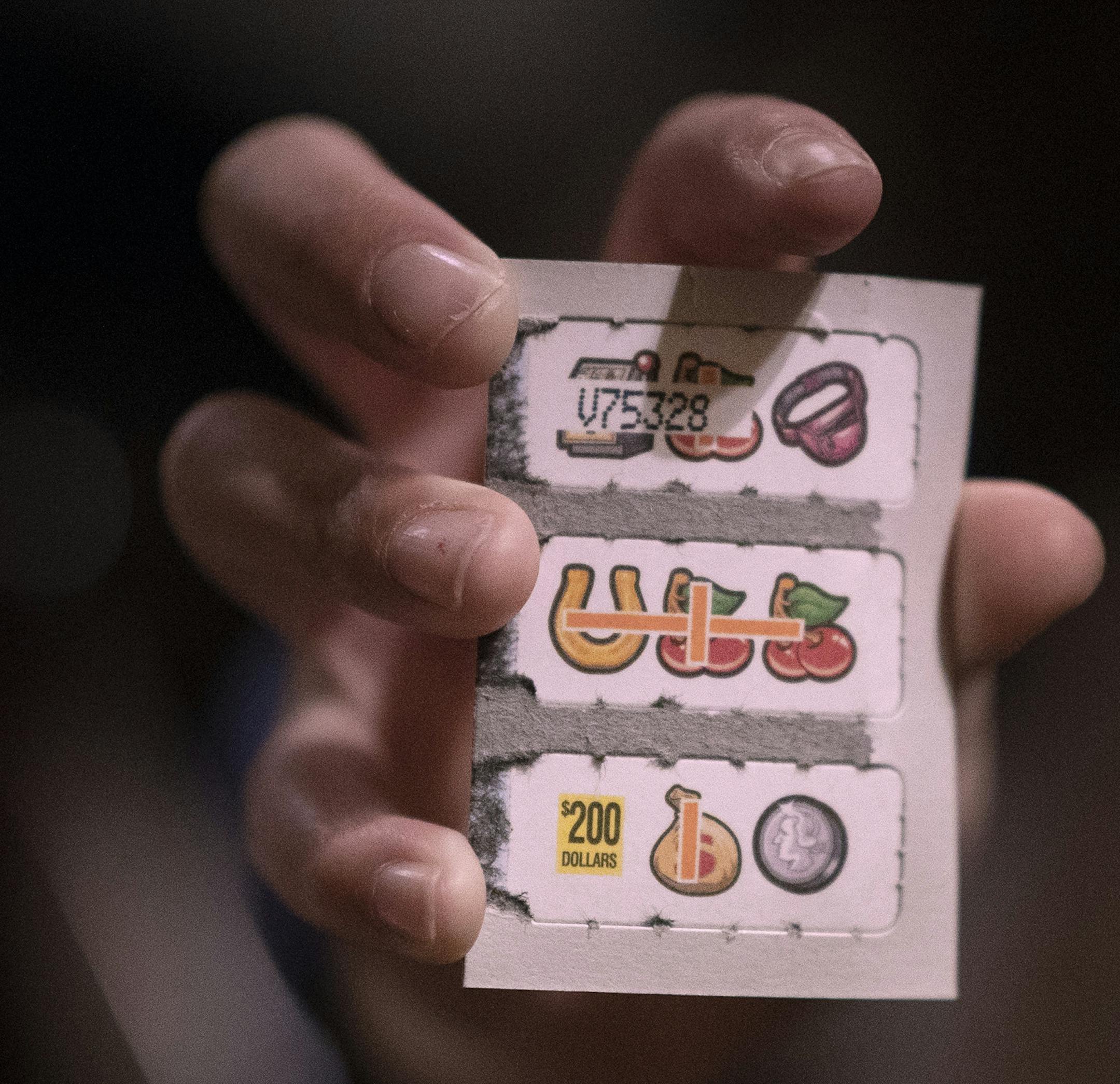 Sana Anetipa (cq) daughter held up a winning ticket of 200.00 that her father purchased while he played pull tabs Wednesday March 6, 2019 at Skinner's Bar in St.Paul, MN.] Jerry Holt • Jerry.holt@startribune.com