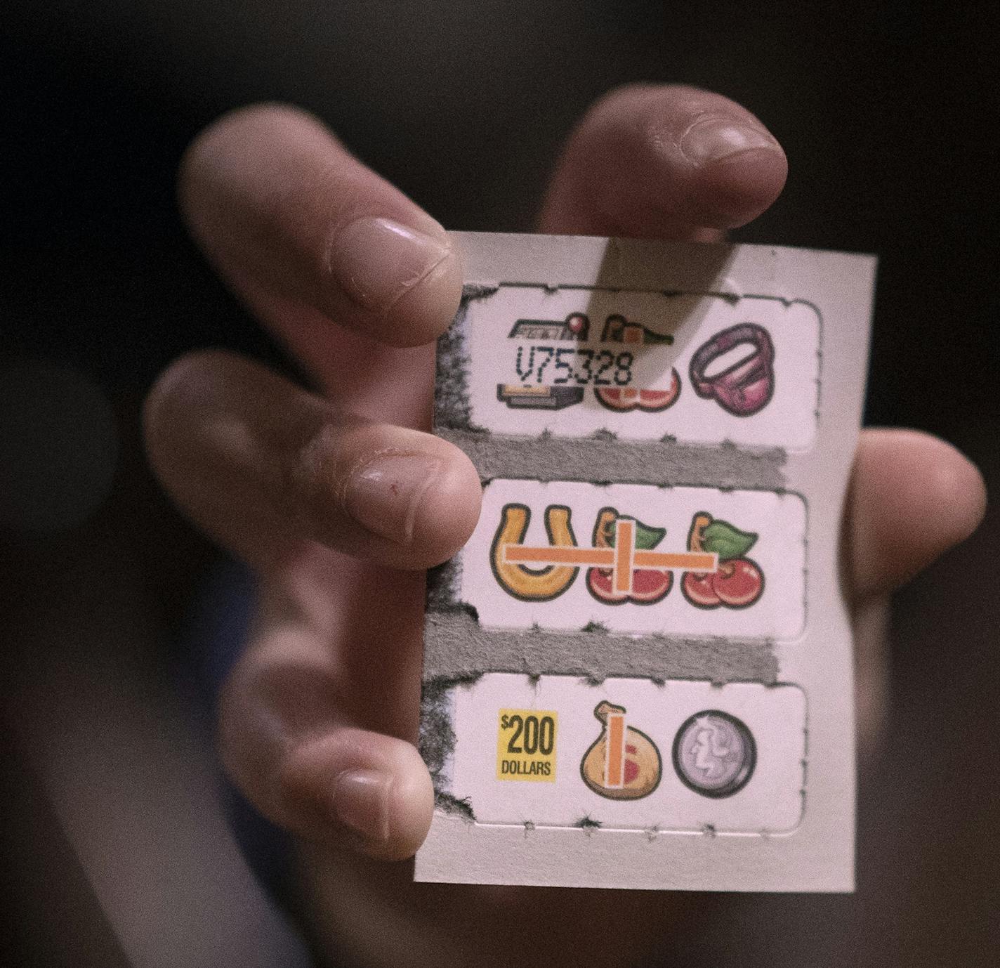 Sana Anetipa (cq) daughter held up a winning ticket of 200.00 that her father purchased while he played pull tabs Wednesday March 6, 2019 at Skinner's Bar in St.Paul, MN.] Jerry Holt &#x2022; Jerry.holt@startribune.com