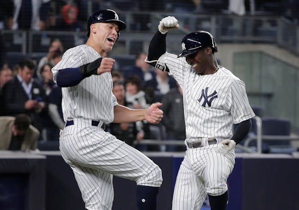 New York Yankees' Didi Gregorius, right, celebrates with Aaron Judge after hitting a two-run home run against the Twins during the fifth inning Tuesda