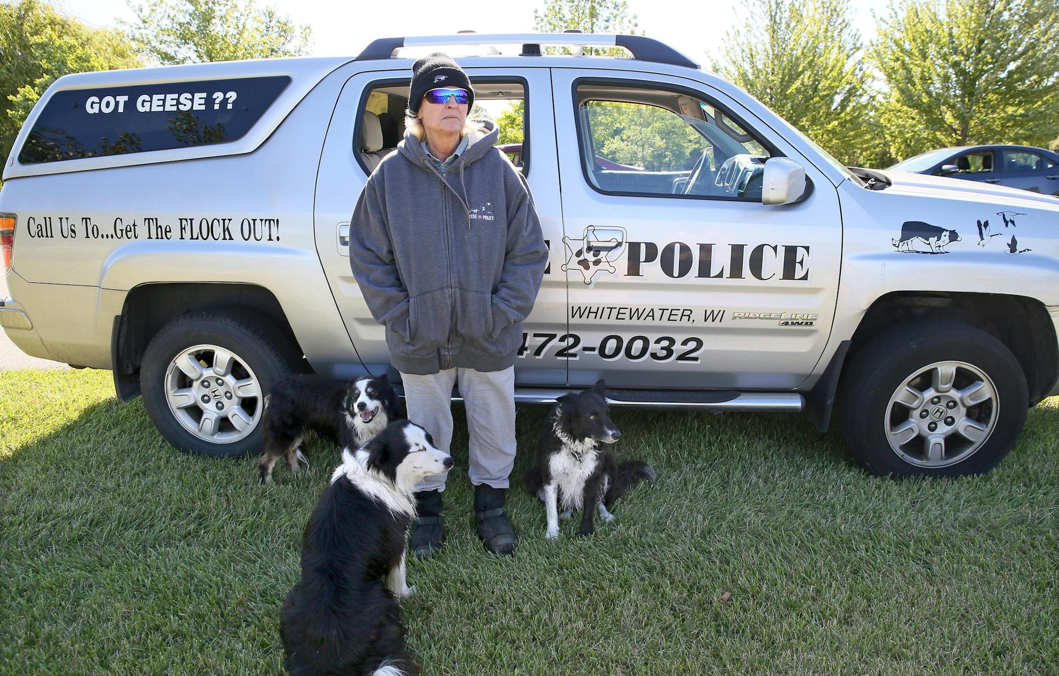 Susan Kinney, the owner of Geese Police, stands with her border collies, Gael, Rocky and Meg, as Kinney surveys the pond for geese. (Michael Sears/Milwaukee Journal Sentinel/TNS) ORG XMIT: 1173001