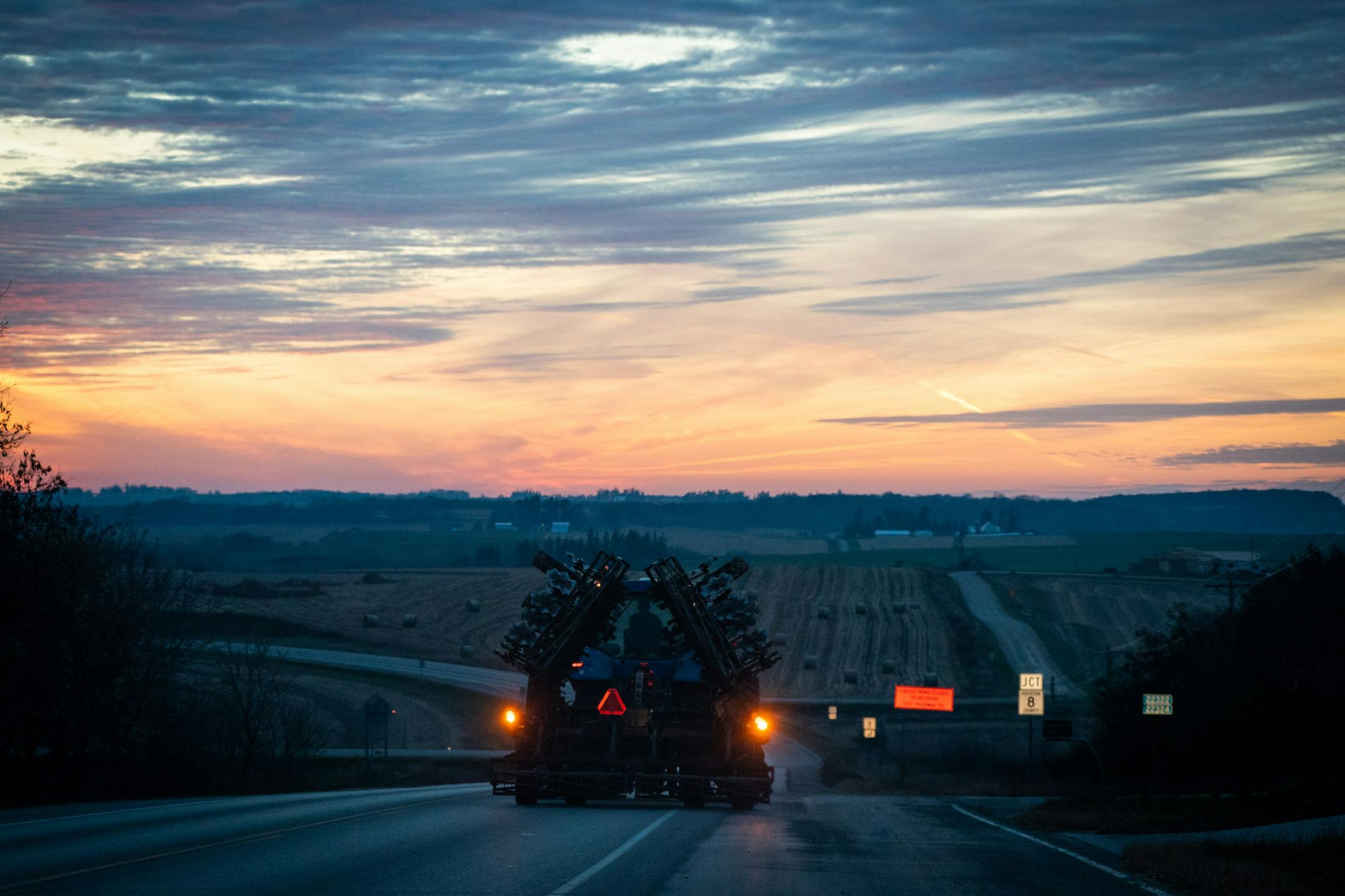 A farmer headed west out of Spring Grove on MN-44 as the sun set in rural Houston County.
