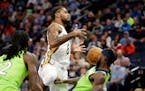 New Orleans Pelicans forward Naji Marshall (8) is called for a charge with defense from Minnesota Timberwolves guard Patrick Beverley, right, in the f