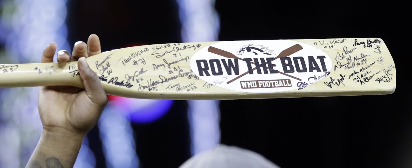 A Western Michigan player holds their Row the Boat oar after the Mid-American Conference championship NCAA college football game against Ohio, Friday, Dec. 2, 2016, in Detroit. (AP Photo/Carlos Osorio)