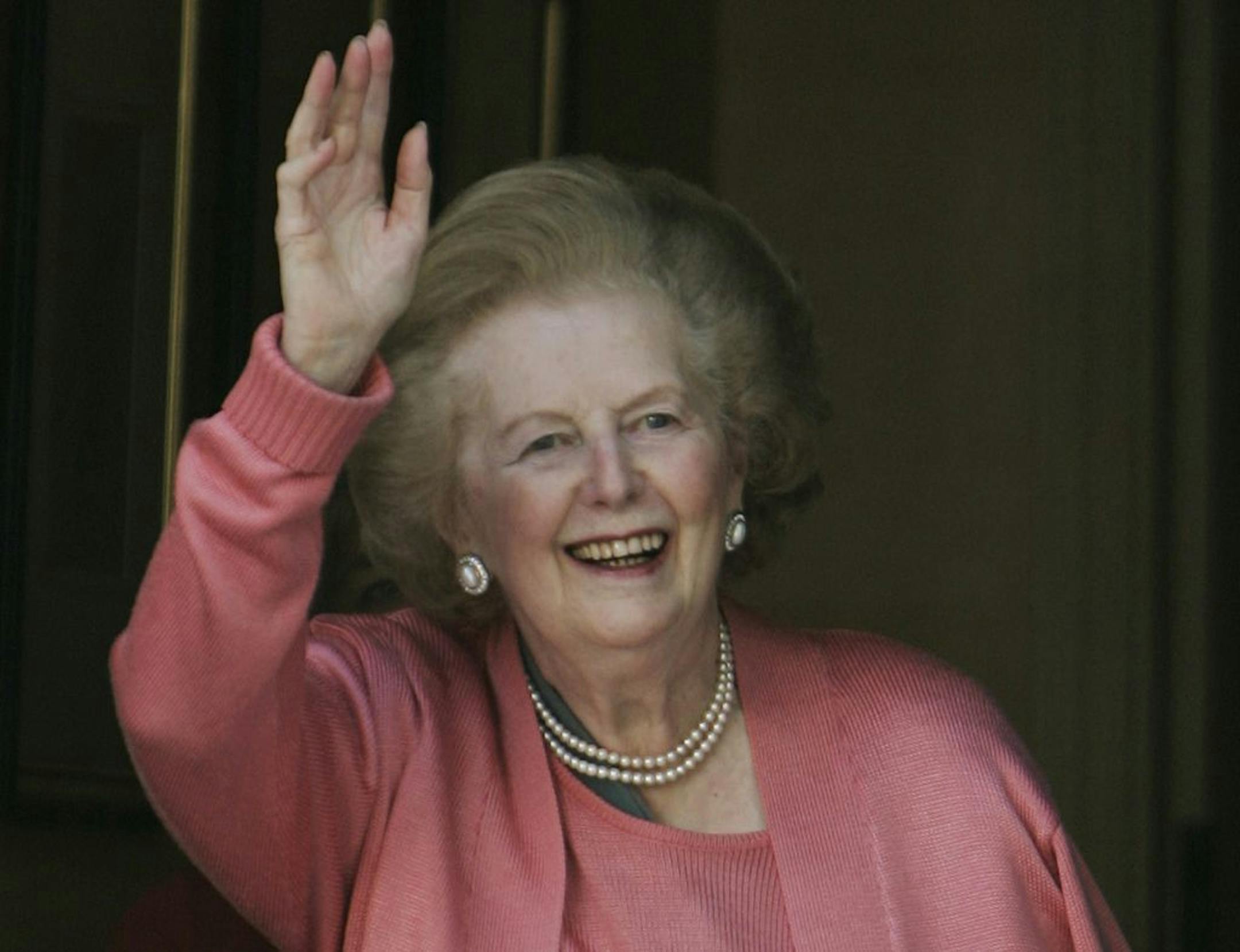 FILE- Former British Prime Minister Margaret Thatcher, gestures to members of the media following her return home from hospital suffering from a broken arm, in central London, in this file photos dated Monday June 29, 2009. 87-year old Thatcher is recuperating at an unnamed hospital, Friday Dec. 21, 2012, after an operation to remove a bladder growth, which was "completely satisfactory", according to adviser Tim Bell, who did not give further details.