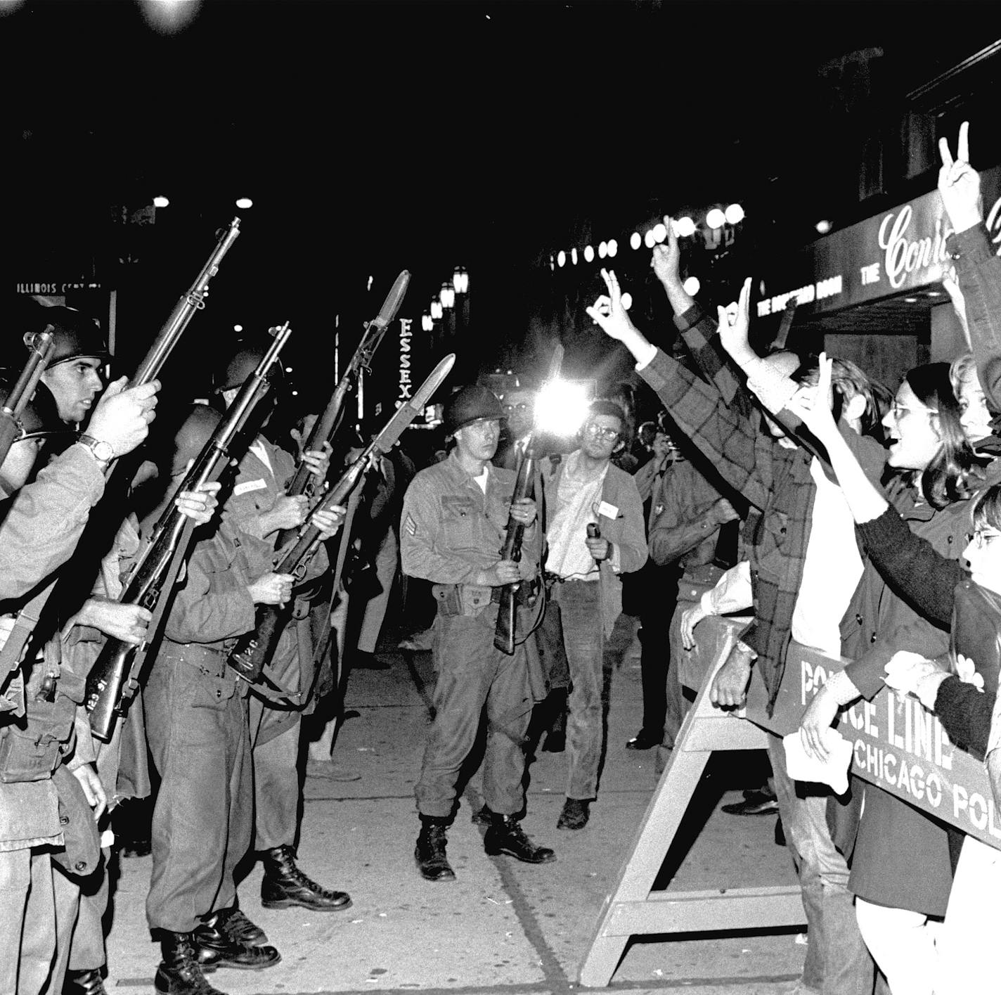 Peace demonstrators taunt Illinois National Guardsmen outside the Conrad Hilton, the Democratic Convention headquarters hotel, August 29, 1968. Earlier police and the demonstrators engaged in a violent clash in which hundreds were injured. (AP Photo/stf) ORG XMIT: CX7