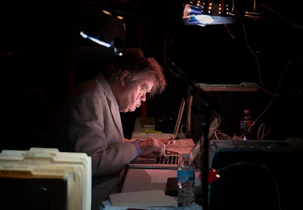 Garrison Keillor writes backstage before the show at the State Theatre.