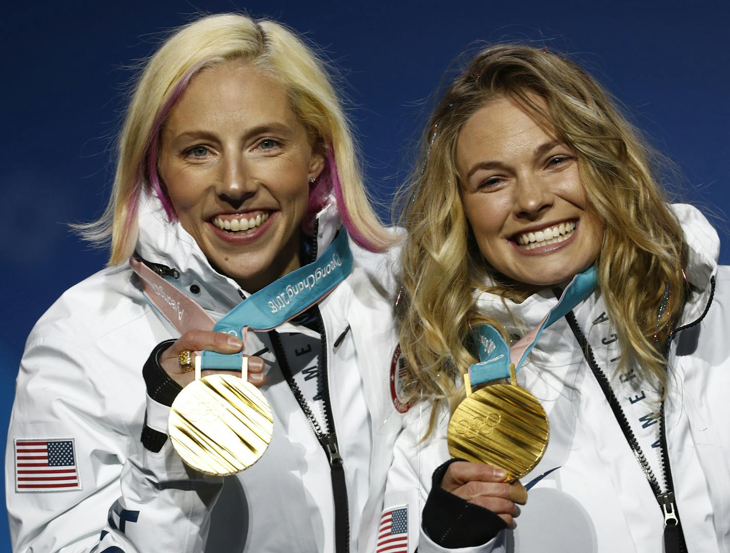 Gold medalists in the women's team sprint freestyle cross-country skiing Kikkan Randall and Jessica Diggins, of the United States, pose during the medals ceremony at the 2018 Winter Olympics in Pyeongchang, South Korea, Thursday, Feb. 22, 2018. (AP Photo/Patrick Semansky)