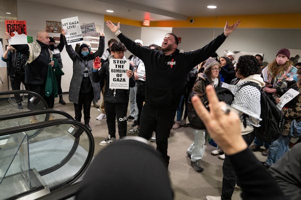 People chant “Free, Free Palestine” outside the meeting after the Minneapolis City Council, meeting as a Committee of the Whole, approved a resolu