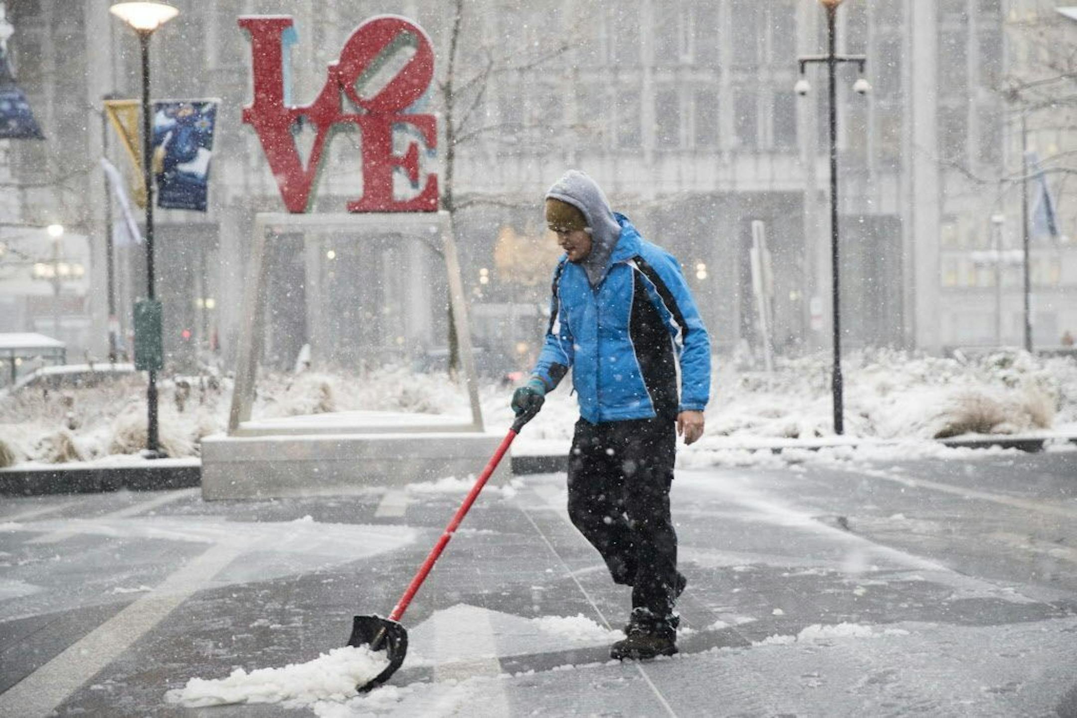A man clears snow from Dilworth Park during a winter storm in Philadelphia, Thursday, Feb. 9, 2017. A powerful, fast-moving storm swept through the northeastern U.S. Thursday, making for a slippery morning commute and leaving some residents bracing for blizzard conditions.