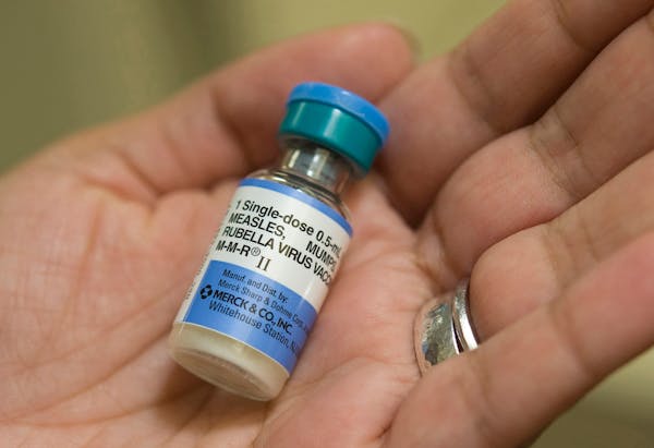 A U.S. doctor holds a dose of the vaccine that protects against measles, mumps and rubella.