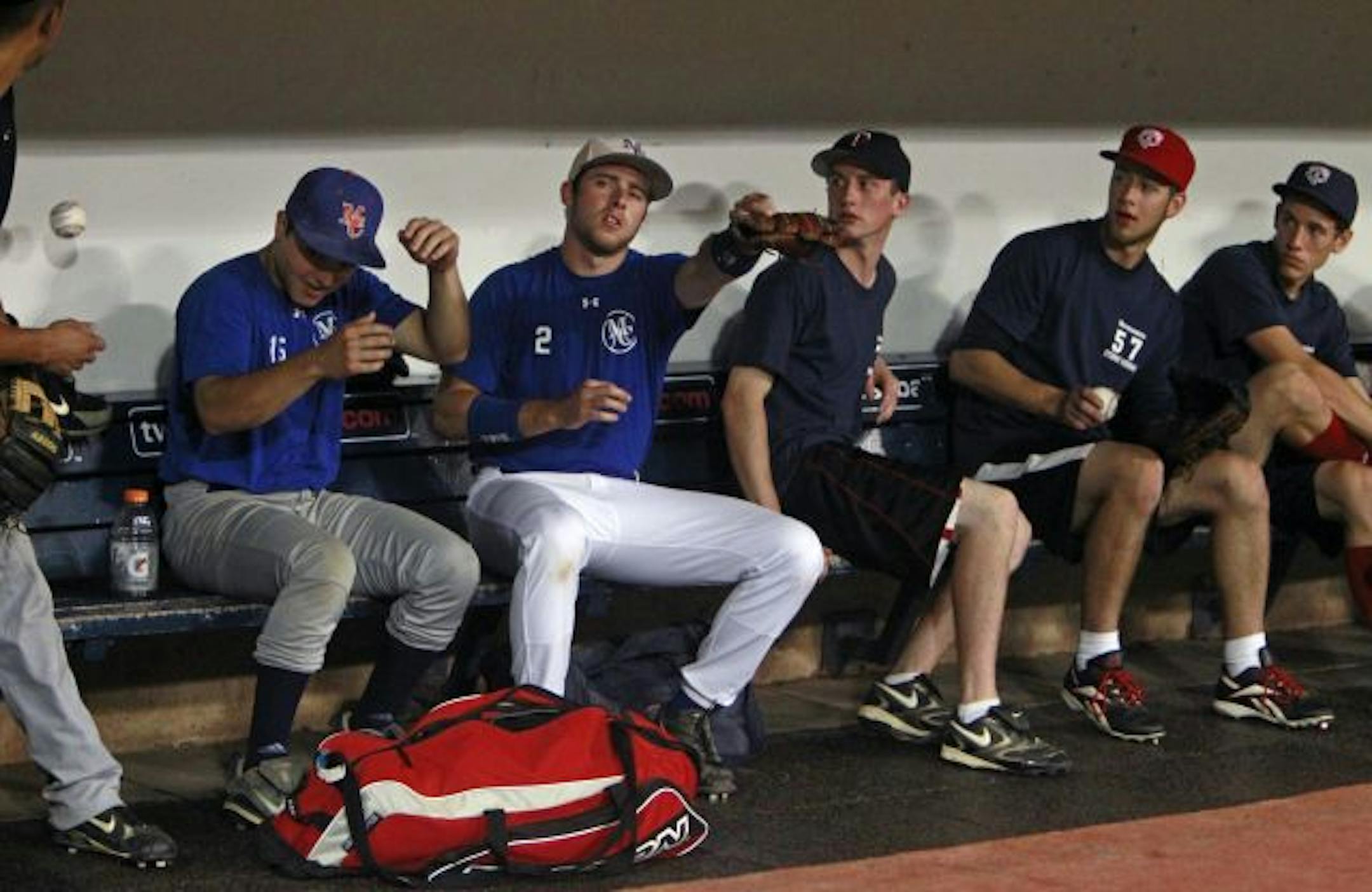 At the Twins open tryouts at the Metrodome, an errant ball thrown to third base from an outfielder trying out ended up in the dugout where other aspiring ballplayers were sitting.