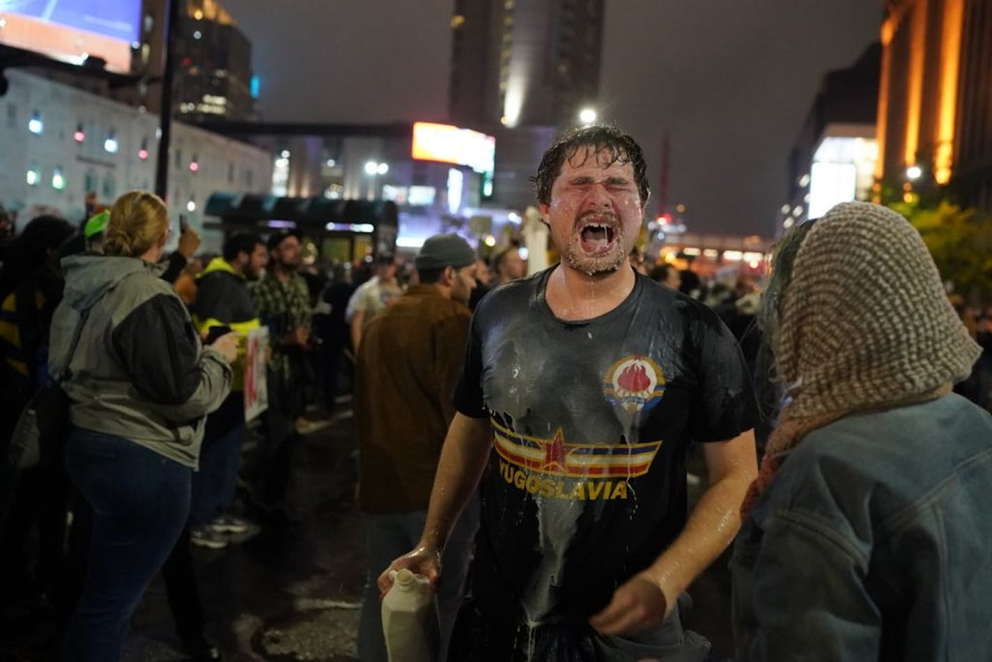 A protester poured milk on his face after being pepper spray led by police outside the Target Center as President Donald Trump visits Minneapolis, Minn., for a campaign rally on October 10, 2019.